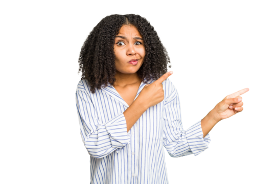 Young african american woman isolated shocked pointing with index fingers to a copy space.