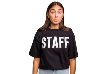 Young caucasian staff woman isolated shrugs shoulders and open eyes confused.