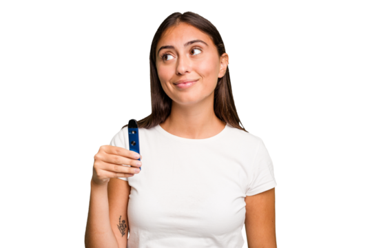 Young caucasian woman holding a electronic cigarette dreaming of achieving goals and purposes