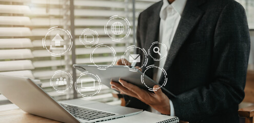 Digital marketing media (website ad, email, social network, mobile app) in virtual screen.Designer hand using tablet payments online shopping,omni channel,laptop computer on desk.