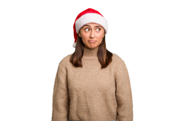 Young caucasian woman celebrating christmas wearing a santa hat isolated confused, feels doubtful and unsure.