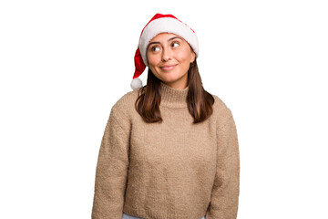 Young caucasian woman celebrating christmas wearing a santa hat isolated dreaming of achieving goals and purposes