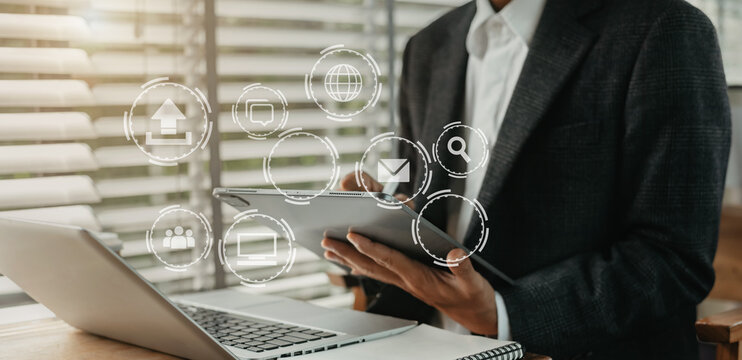 Digital marketing media (website ad, email, social network, mobile app) in virtual screen.Designer hand using tablet payments online shopping,omni channel,laptop computer on desk.