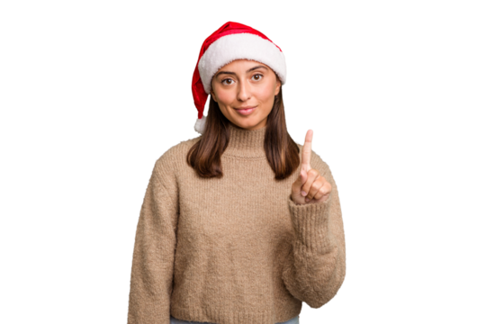 Young caucasian woman celebrating christmas wearing a santa hat isolated showing number one with finger.