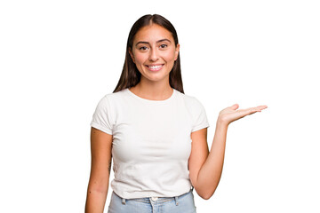 Young cute caucasian woman isolated showing a copy space on a palm and holding another hand on waist.