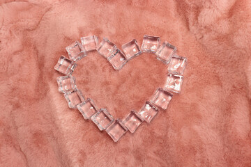 Ice Cubes forming Heart shape on a beautiful Baby Pink Faux Fur Luxury shag or blanket,  Romantic,  Valentine's Day, Holiday concept, Holiday decoration