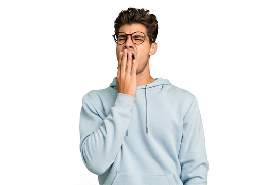 Young caucasian handsome man isolated yawning showing a tired gesture covering mouth with hand.