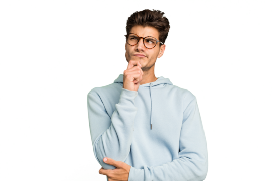 Young caucasian handsome man isolated thinking and looking up, being reflective, contemplating, having a fantasy.