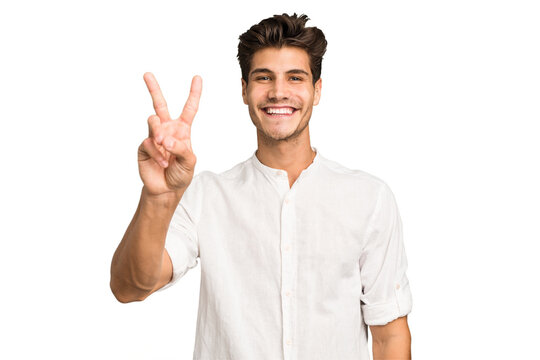 Young caucasian handsome man isolated showing victory sign and smiling broadly.