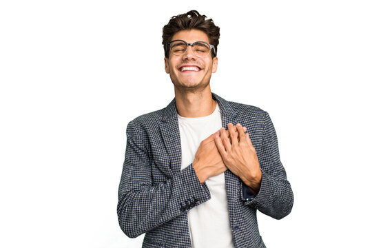 Young caucasian handsome man isolated laughing keeping hands on heart, concept of happiness.