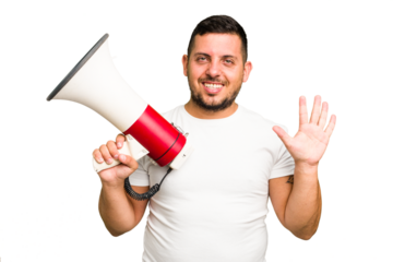 Young caucasian man holding a megaphone isolated smiling cheerful showing number five with fingers.
