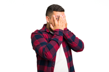 Young caucasian man isolated blink through fingers frightened and nervous.