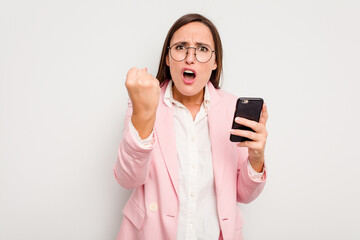 Business caucasian woman holding a mobile phone isolated on white background showing fist to camera, aggressive facial expression. - Powered by Adobe