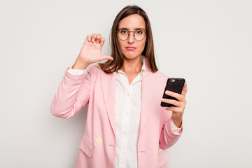 Business caucasian woman holding a mobile phone isolated on white background showing a dislike gesture, thumbs down. Disagreement concept.