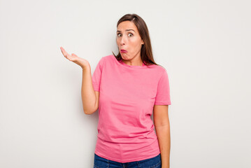 Young caucasian cute woman isolated on white background doubting and shrugging shoulders in questioning gesture.