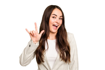 Young caucasian woman isolated on green chroma background showing a horns gesture as a revolution concept.