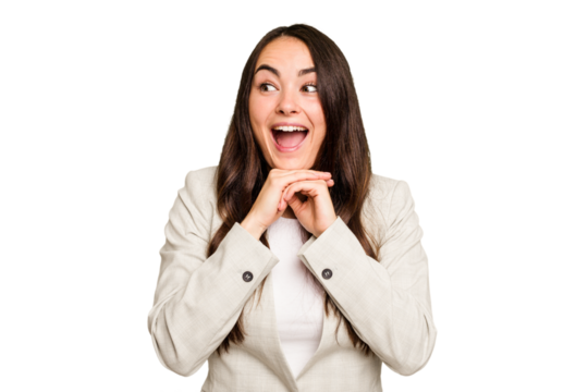 Young caucasian woman isolated on green chroma background keeps hands under chin, is looking happily aside.