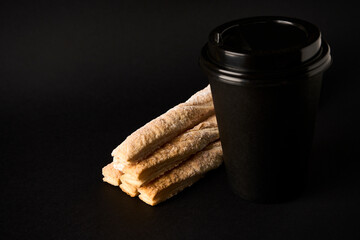 Paper coffee cup and Puff pastry sticks with cinnamon