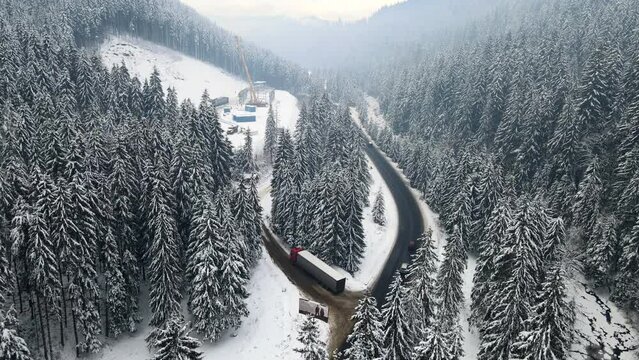 aerial view of snowed winter road in carpathian mountains