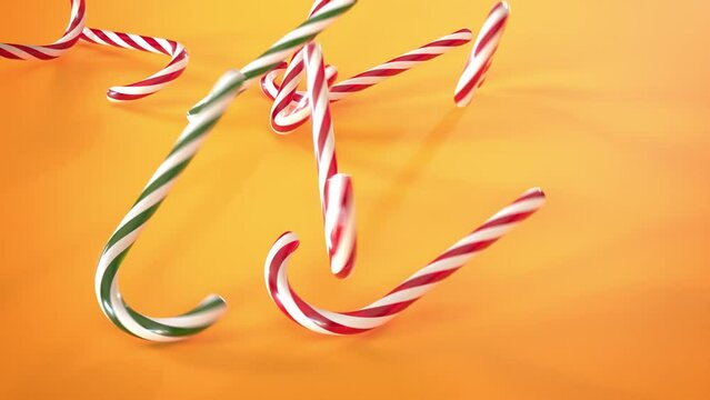 Close-up of a lot of red, green and white candy canes falling on an orange background, 3D anim