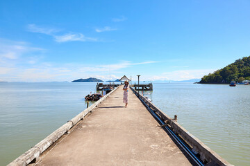 A woman standing on cement pier