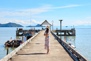 A woman standing on cement pier