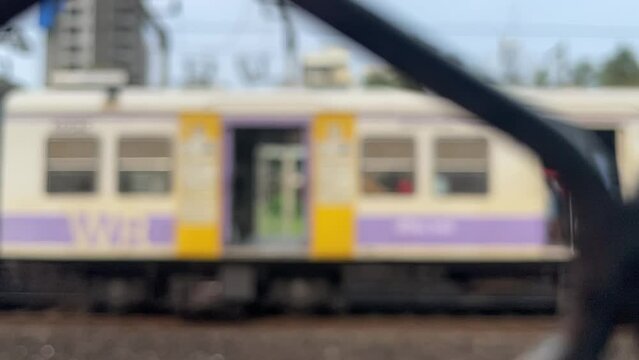 Blurred View Of Local Train Moving On Railway In Slow Motion In Mumbai, India. defocused shot