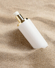 Blank one pump Cream bottle on beige sand close up. Cosmetic mockup