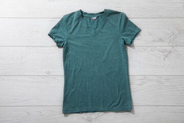 Green shirt mockup - tshirt with autumn leaves on white wooden desk