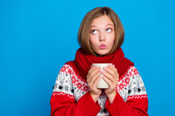 Photo of minded cute lady wear cozy clothes look up empty space offer proposition discount hot drinks isolated on blue color background