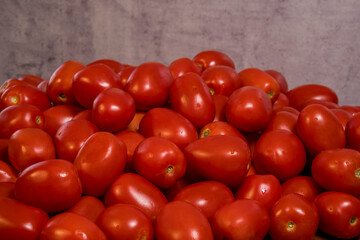 The Roma tomato or Roma is a plum tomato popularly used both for canning and producing tomato paste because of its slender and firm nature. Selective Focus pile of tomatoes.