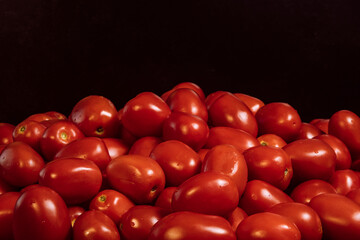 The Roma tomato or Roma is a plum tomato popularly used both for canning and producing tomato paste because of its slender and firm nature. Selective Focus pile of tomatoes.