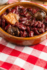 View of red bean stew on red kitchen cloth, selective focus, vertical, with copy space