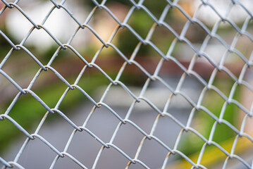 Fototapeta premium Aluminum fence metal fence texture with river and village background.