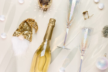 Minimal New Year flat lay, white sparkling wine, trend glasses, champagne bottle, dwarf dress,...