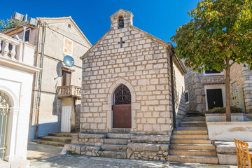 Fototapeta premium Square and church in town of Omisalj, Krk island in Croatia