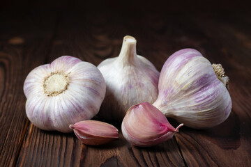 Garlic cloves on wooden table. Fresh peeled garlics and bulbs.