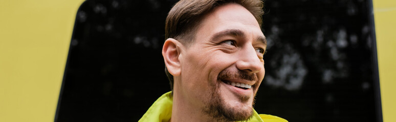 Obraz premium Portrait of paramedic looking away near ambulance vehicle outdoors, banner.