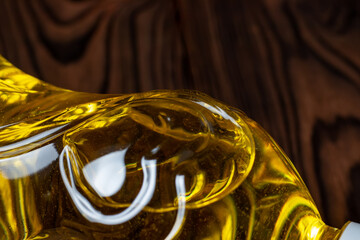 Sunflower oil in bottle on wooden background