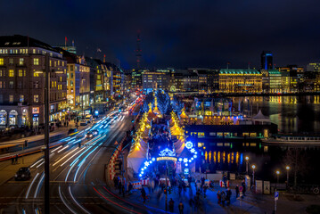 Fototapeta na wymiar View onto the traffic at the christmas market White magic at Jungfernstieg in Hamburg