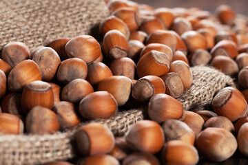 close up of hazelnuts on wooden table, top view