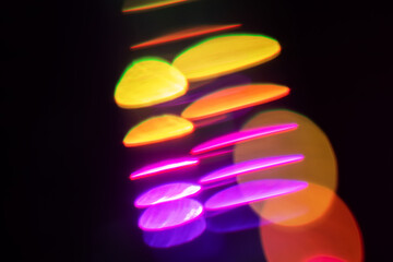 Blurred Light painting one exposure in camera. light glares with a spectral gradient on a dark...