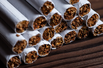heap of cigarette on a wooden background