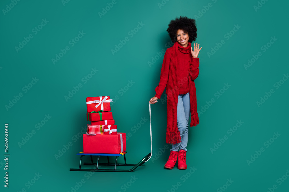 Sticker full length portrait of cheerful friendly person arm palm waving hi pile stack giftbox sled isolated