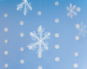 Fototapeta na wymiar hanging Christmas decoration in the form of delicate snowflakes in the frost