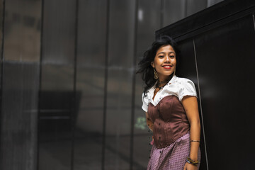 An Asian girl in a vintage Asian traditional long dress, fashion photography on a black background