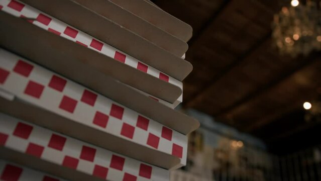 Close-up - pizza boxes stacked on top of each other in a restaurant