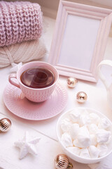  Winter, Christmas, New Year decoration composition, concept, background. White Mug, cup of hot tea, coffee, meringue, knitted plaid. Christmas lights. Christmas mood morning. Xmas greeting card.