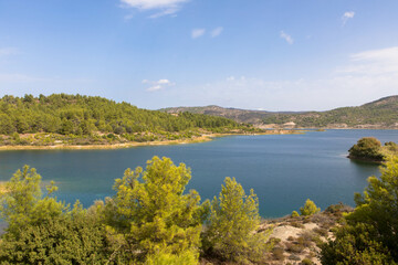 Fototapeta na wymiar Panoramic view of Gadouras Dam. Solving the important and crucial water supply problems. Near the villages of Lardos and Laerma in the southern part of the island. Rhodes, Greece.