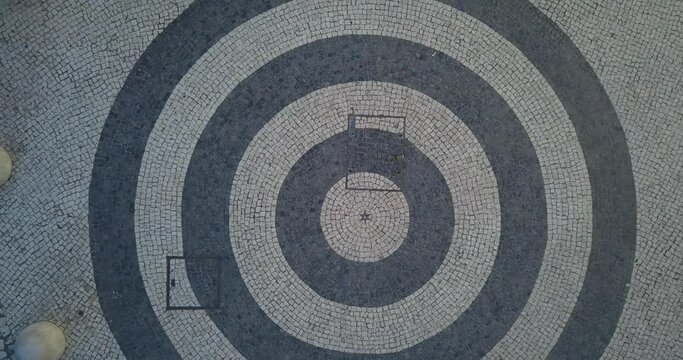 bottom-up aerial view of the cobblestone at Diana's Arch in Rossio Square, Lisbon, Portugal